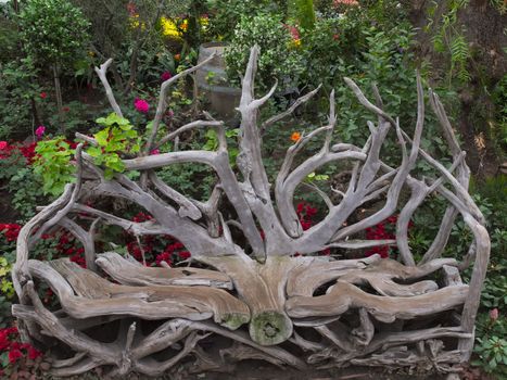 close up of rustic log chair in garden 