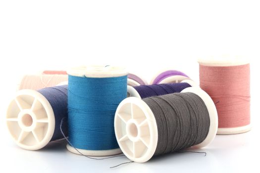 Threads in spools isolated in white background 