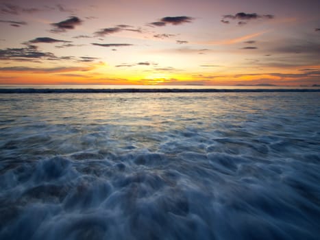 Landscape of sea with dramatic wave in sunset.