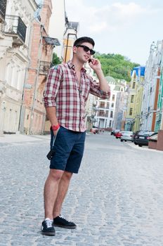 Young man talking on a cell phone on the street.