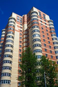 High modern apartment building under blue sky