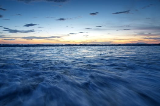 Landscape of sea with dramatic wave in sunset.   