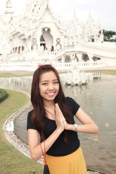 Beautiful Thai girl greeting on a background of Thai temple
