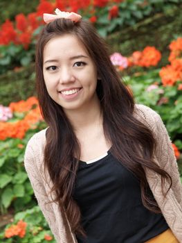 A smile of Asia beautiful girl  on a colorfull flower background 