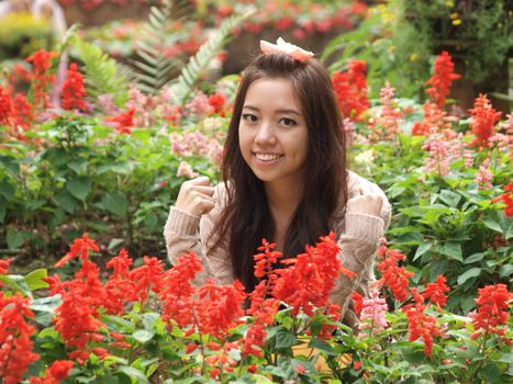 A smile of Asia beautiful girl  on a background of colorfull flower