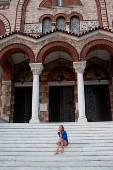 young and beautiful woman sitting on the steps of