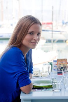 Young and beautiful girl sitting at a coffee shop waiting for my order