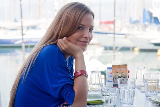 Young and beautiful girl sitting at a coffee shop waiting for my order