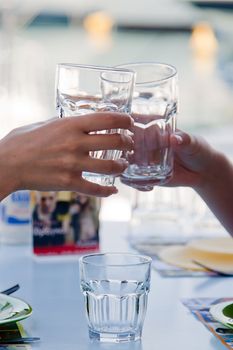 Glasses of water in graceful female hands