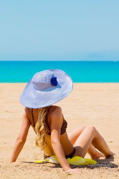 Photo of a young and beautiful woman resting on the sea coast