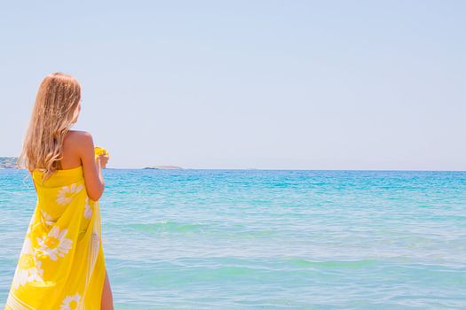 Photo of a young and beautiful woman resting on the sea coast