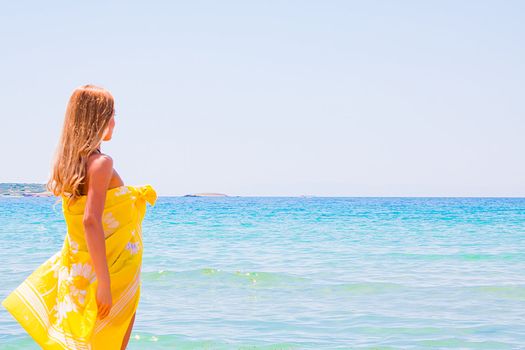 Photo of a young and beautiful woman resting on the sea coast