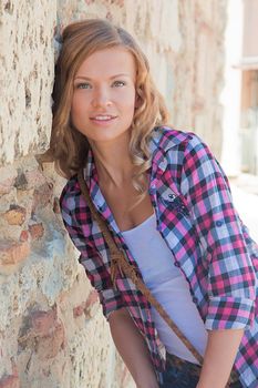 Photo of a young and beautiful girl walking down the street