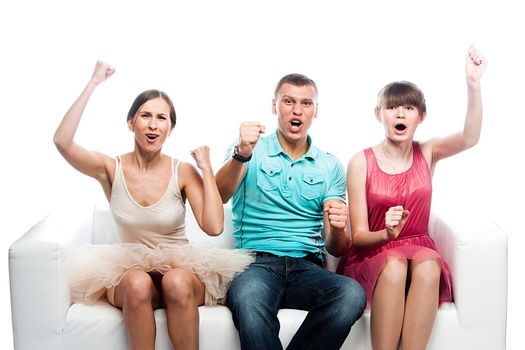 Group of sports fans watching the competition sitting on a white sofa