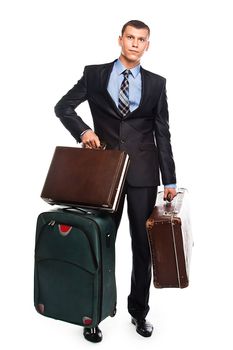 Young successful businessman in a business suit with three suitcases and a journey