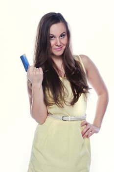 Young and beautiful girl with a credit card in the hands of blue