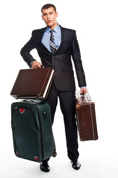 Young successful businessman in a business suit with three suitcases and a journey