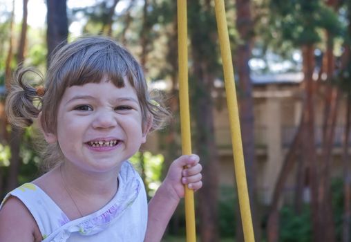 Little girl on swing in park