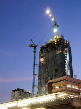 night shot of construction site with tower crane loader