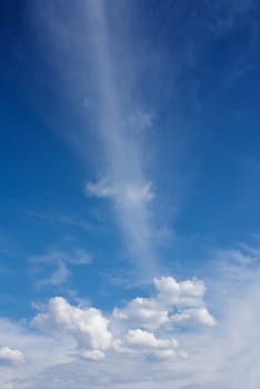 White fluffy clouds against a blue day sky