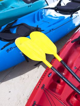 Yellow kayak oar on the red kayak 