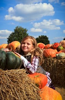 Cute little girls in a pumpkin patch