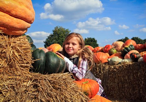Cute little girls in a pumpkin patch