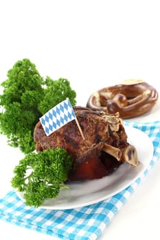 a knuckle with pretzels and parsley on a white background