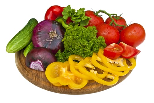 Group of vegetables on cutting board isolated over white