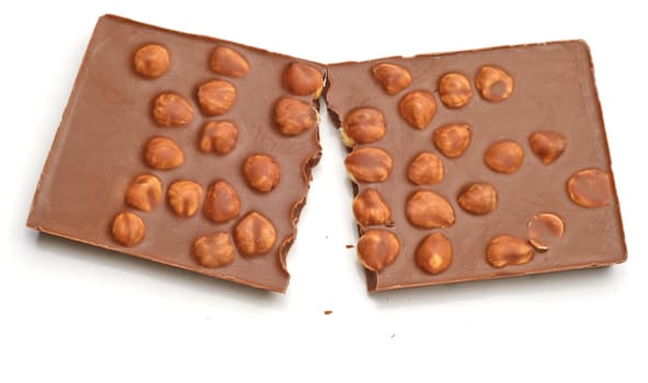 Cracked bar of milk Chocolate with nuts.