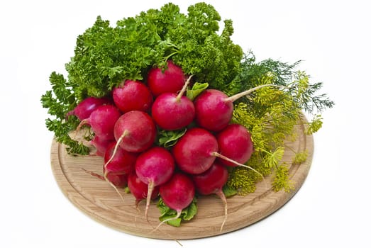 Radish and other vegetables on wood cutting board