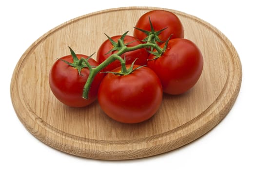 Tomatos on wood cutting board isolated over white