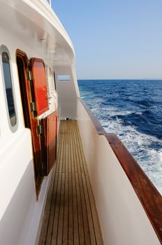 Deck of big wooden yacht in the sea