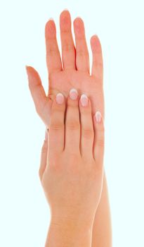 Beautiful female hands with nice french manicure isolated on blue background