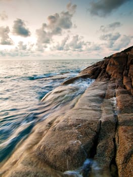 Beautiful seascape. Sea and rock at the sunset