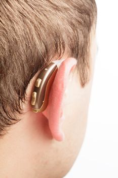 Hearing aid on the man's ear closeup