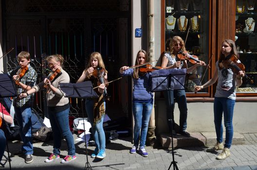 VILNIUS, LITHUANIA MAY 2012. Young people playing violin in street music day in Old Town street. Free event.