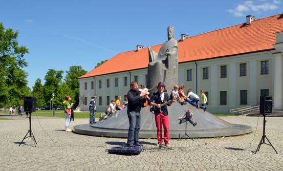 VILNIUS, LITHUANIA MAY 2012. Musicians playing instruments and singing near great duke Mindaugas sculpture. Street Music Day.