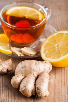 Tea cup with lemon and ginger on the wooden table.