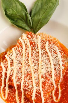 Traditional italian lasagna with tomato sauce and basil