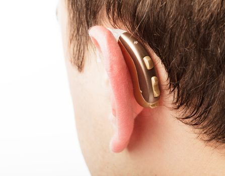 Hearing aid on the man's ear closeup