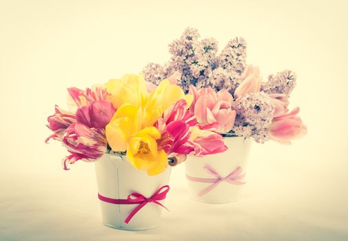 Bouquets from tulips and lilac on white