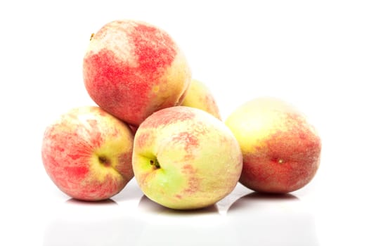 Group of ripe peaches isolated on white