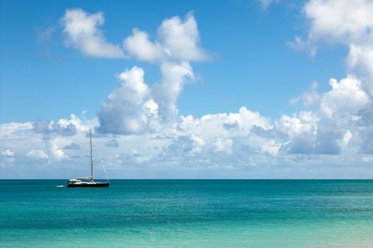 Beautiful Sunny Seascape with Anchored Yacht and Blue Sky with Fluffy Clouds