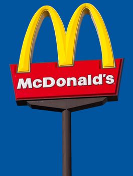 CAIRNS, AUSTRALIA - DECEMBER 2: McDonald's logo on a sign against a blue sky background on Dec. 3, 2010 in Cairns, Australia.