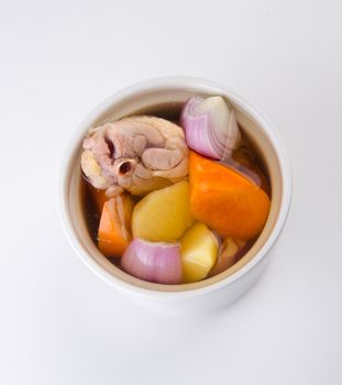 Chicken and herb soup in pot, Chinese food style.