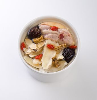 Chicken and herb soup in pot, Chinese food style.