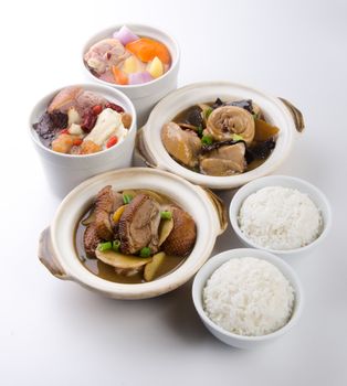 Chicken and herb soup in pot, Chinese food style.