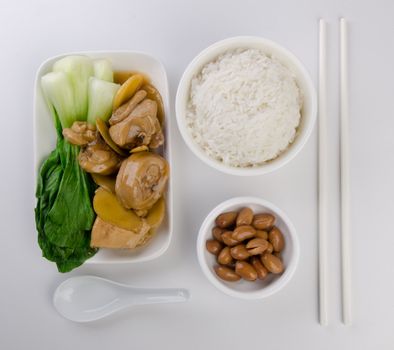 Chicken with rice and vegetables in background