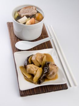 Chicken and herb soup in pot, Chinese food style.